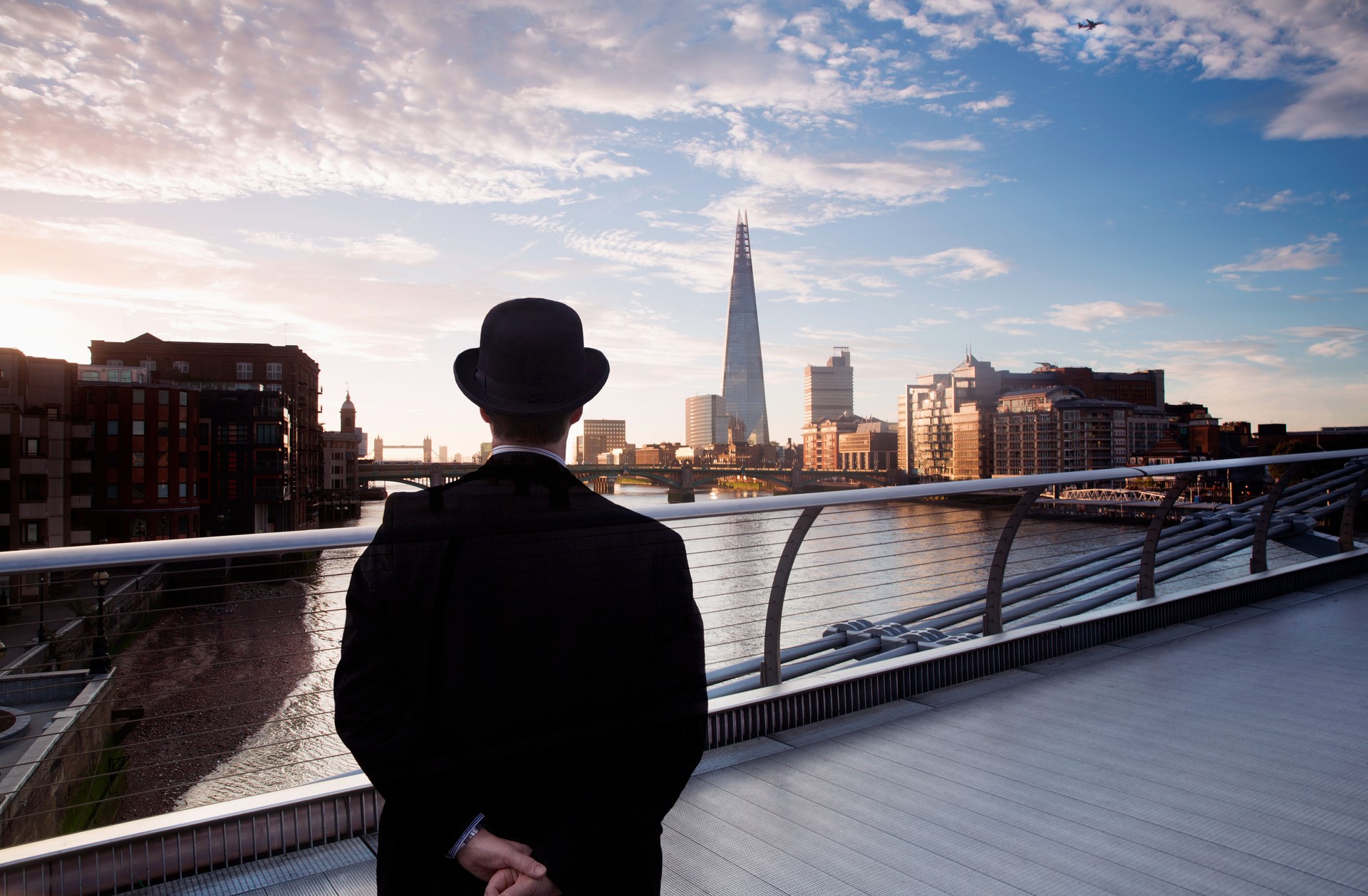 Businessman on bridge looking out