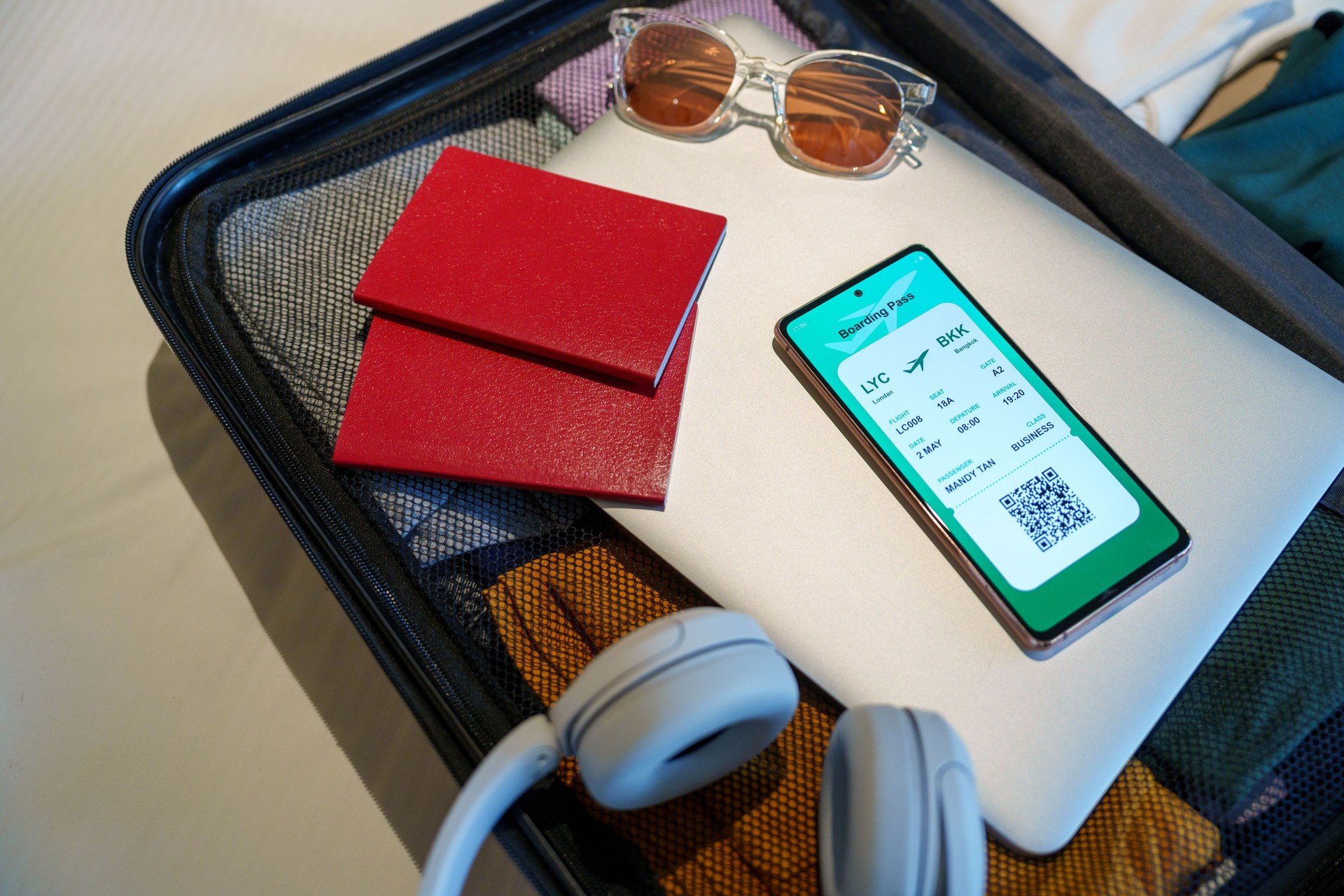 Preparing for Travel, Boarding Pass on Smartphone with Essentials in Luggage