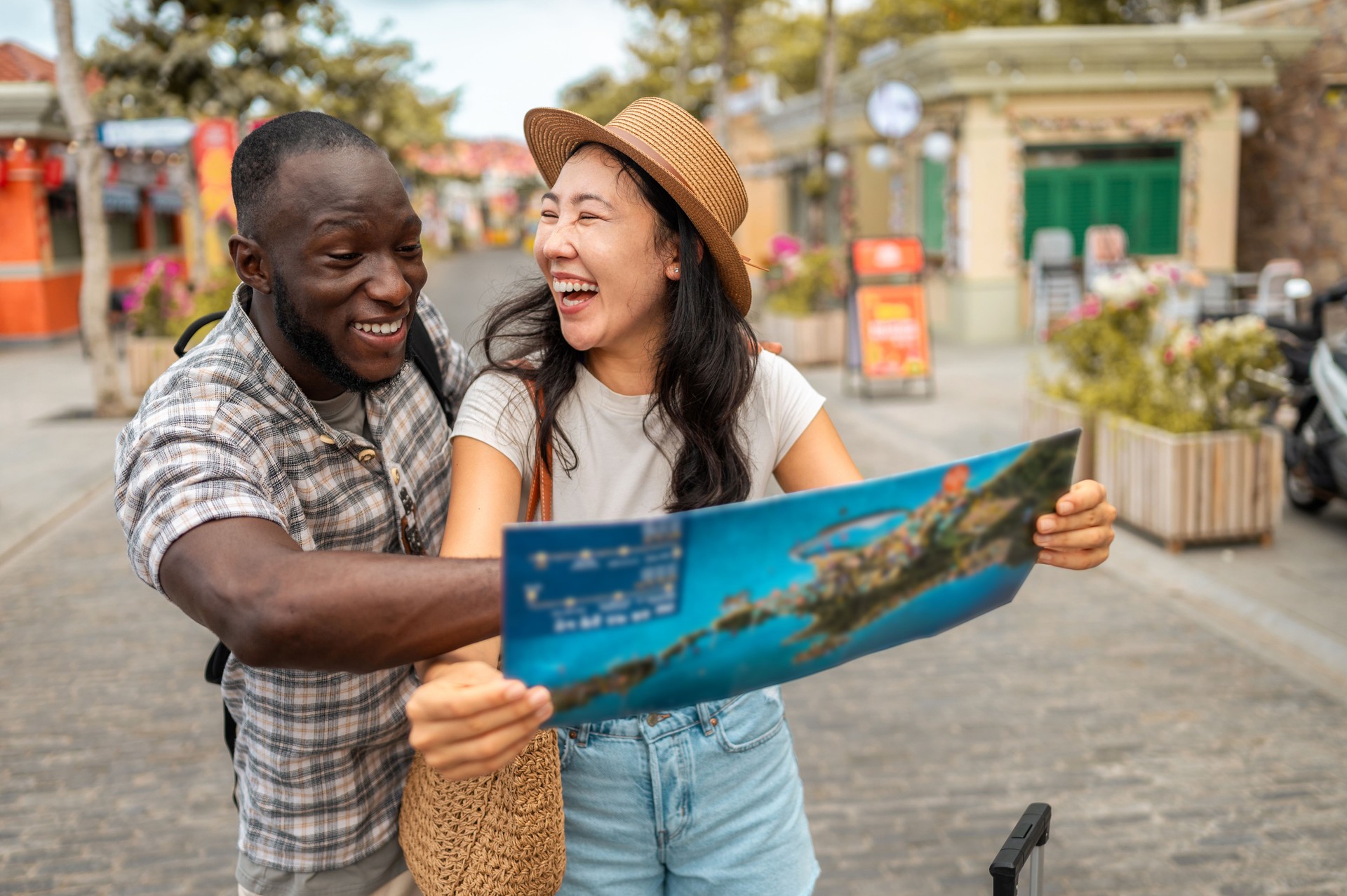 Joyful Diverse Couple Exploring with Map on Travel Adventure